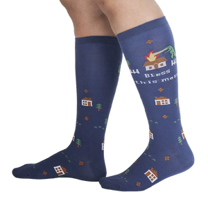 Lifestyle shot of 'Bless This Mess' socks on a person's legs, showcasing the sock's length and design.