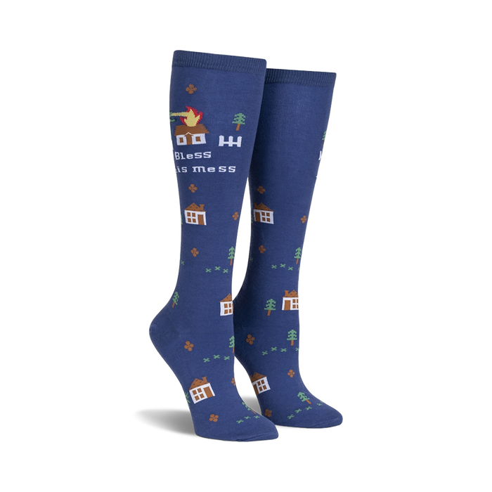 Pair of navy blue knee-high socks with a whimsical design.  Features small houses, trees, and a burning house with the text 'Bless This Mess'.