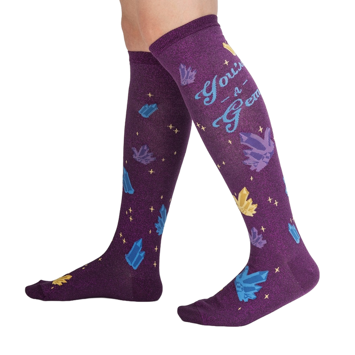 Lifestyle shot showcasing the 'You're a Gem' knee-high socks on a person's legs, showing off the design and fit.