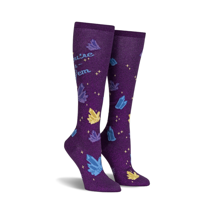 Pair of purple knee-high socks with a scattered crystal design and the text 'You're a Gem'.  Crystals are blue, yellow, and sparkle.