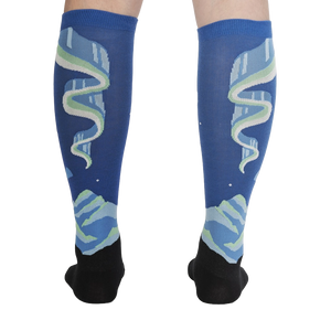 Rear view of the socks on a model's legs, highlighting the symmetrical design and glow-in-the-dark feature.