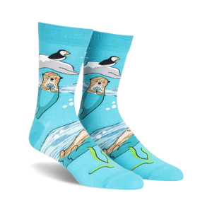 Crew socks in teal featuring otters holding flowers, puffins on ice floes, and an ocean scene. Made with space dye yarn.
