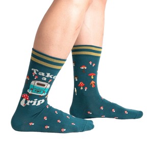 Lifestyle shot of a person wearing teal 'Take A Trip' socks, showcasing the socks on the feet.
