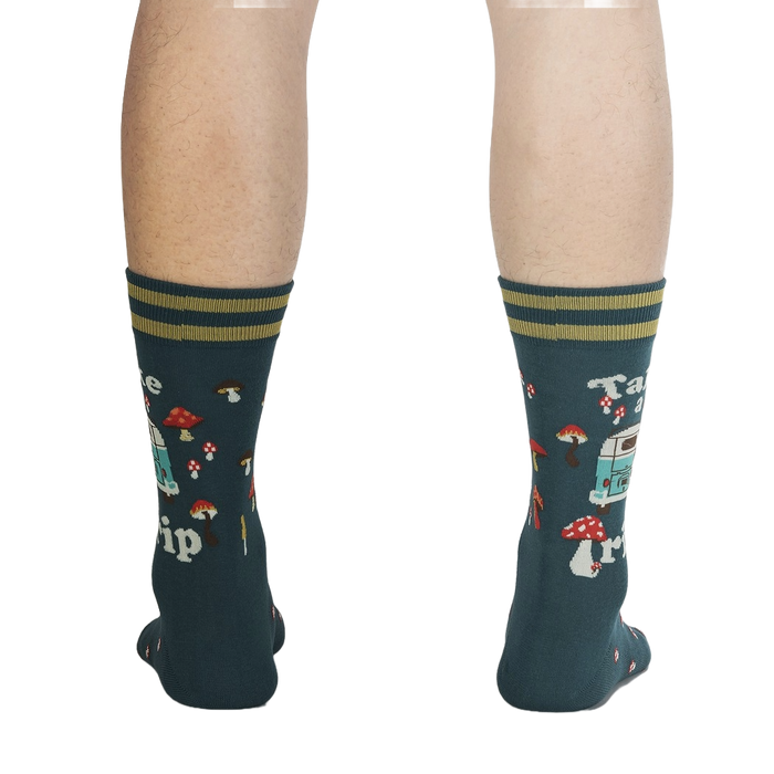 Rear view of a person wearing the teal 'Take a Trip' socks, displaying the back design