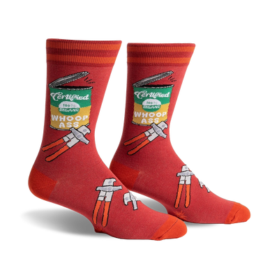 Pair of men's crew socks in red with an illustrated can of 'Whoop Ass' and tools.  Features orange stripes at the top.