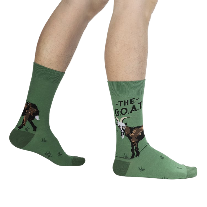 Lifestyle shot of a person wearing the green goat socks.