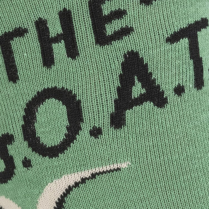 Close-up of the sock's knit texture showing the 'The G.O.A.T.' text and a goat's head.