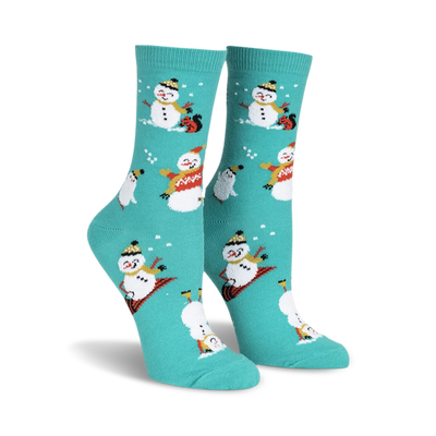 Teal crew socks with a whimsical pattern of snowmen snowboarding, ice skating, and playing in the snow.