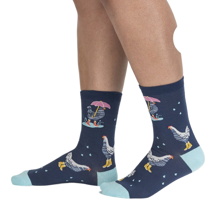 Lifestyle shot of a person's legs wearing the Chicken Little socks, highlighting the fit and pattern.