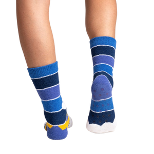 Rear view of the socks on a person's feet, showing the gripper soles.