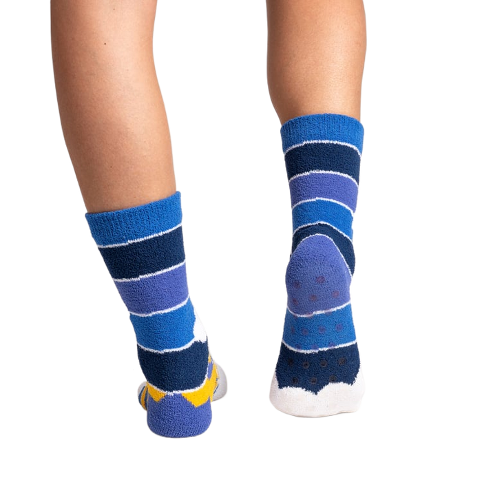 Rear view of the socks on a person's feet, showing the gripper soles.
