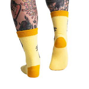 Back view of the yellow butterfly socks; highlighting the mustard yellow cuff and heel.