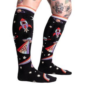 Close-up of 'You Are Outta This World' knee-high socks on a model's legs, showcasing the design.