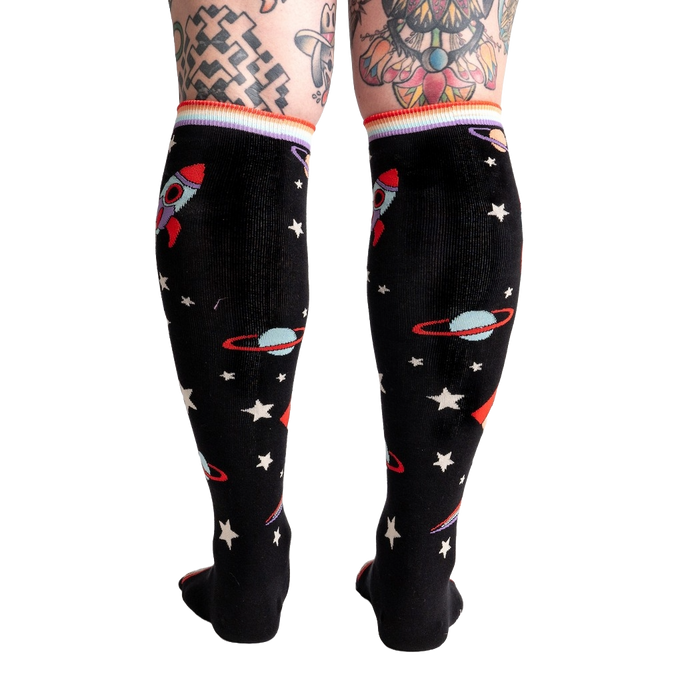 Back view of the socks on a model's legs, showing the full sock pattern.