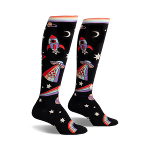 Pair of black knee-high socks with rockets, aliens, pizza slices, rainbows, and stars. Colorful, playful design.