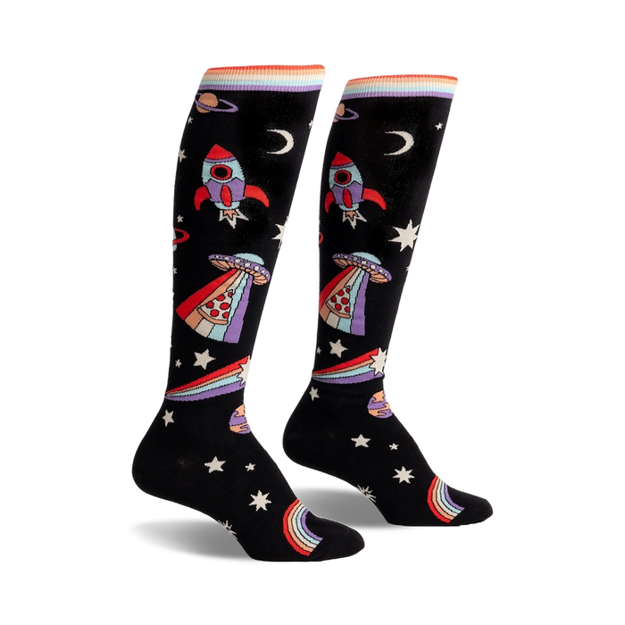 Pair of black knee-high socks with rockets, aliens, pizza slices, rainbows, and stars. Colorful, playful design.