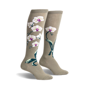 Pair of women's knee-high socks in sage green with a design of white orchids and dark green leaves.