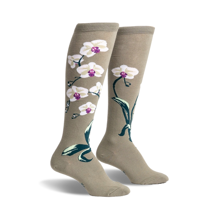 Pair of women's knee-high socks in sage green with a design of white orchids and dark green leaves.