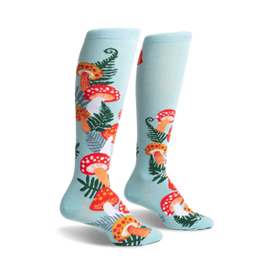 Pair of pastel blue knee-high socks adorned with a whimsical pattern of red and orange mushrooms and green ferns.