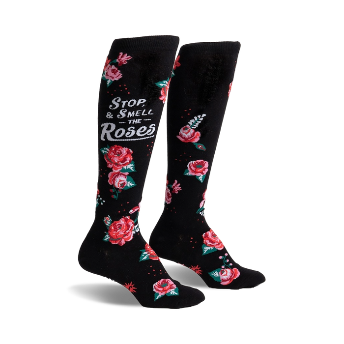 black knee-high socks with a floral pattern of red, pink, and white roses and the message 