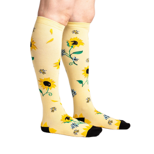 Lifestyle shot: Person wearing the sunflower knee-high socks, showing the design on the legs.