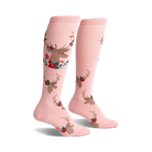 Pair of pink knee-high socks featuring a repeating pattern of gold deer heads accented with red and teal flowers.