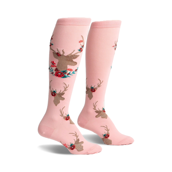 Pair of pink knee-high socks featuring a repeating pattern of gold deer heads accented with red and teal flowers.