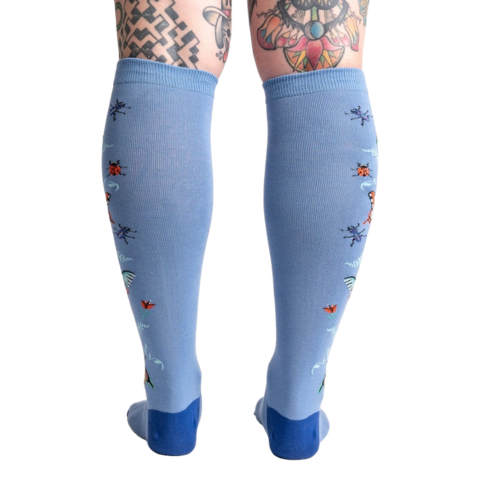 Back view of the light blue knee-high socks showcasing the full design featuring butterflies and ladybugs.