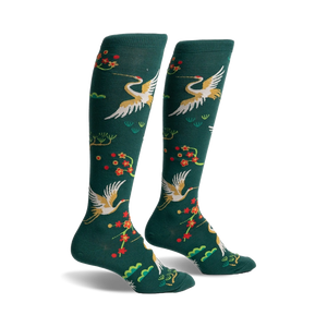 Pair of women's knee-high socks in hunter green. Features gold cranes, red blossoms, and green foliage.