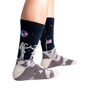 Lifestyle shot of a person's legs wearing the 'High-est 5' socks against a black background.