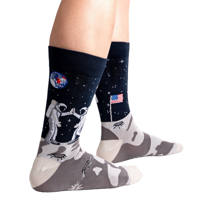 Lifestyle shot of a person's legs wearing the 'High-est 5' socks against a black background.
