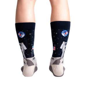 Rear view of a person wearing the 'High-est 5' socks, showcasing the full design on both socks.