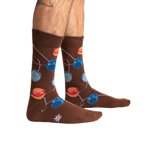 Lifestyle shot of a man's legs wearing the brown yo-yo socks.