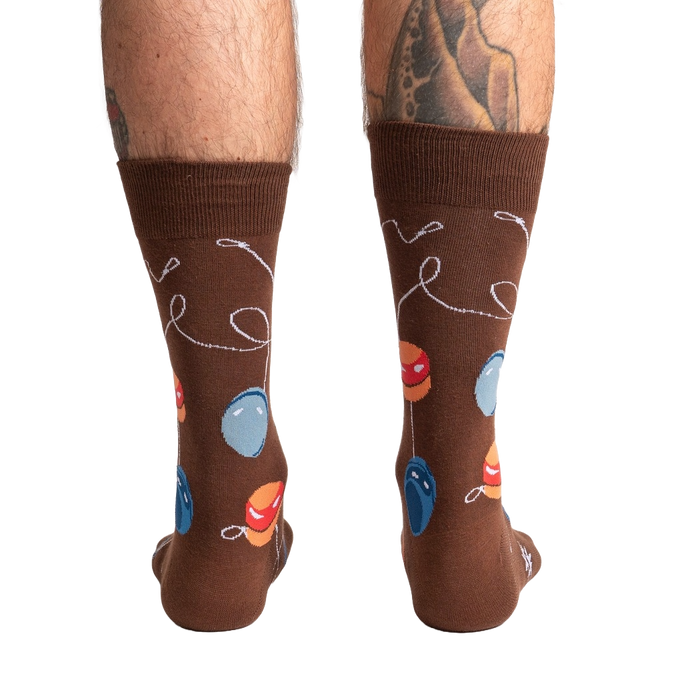 Rear view of a man's legs wearing the brown yo-yo socks.