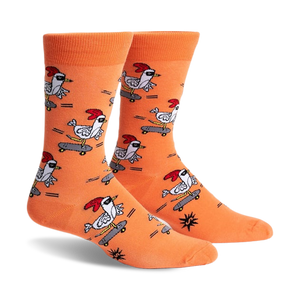 Pair of orange crew socks featuring a repeating pattern of chickens skateboarding.  The chickens wear shades and red combs.