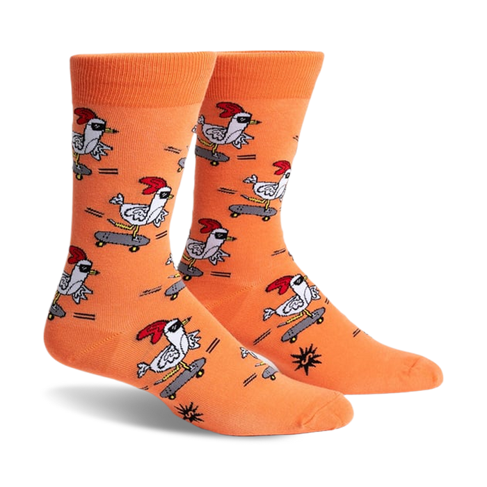 Pair of orange crew socks featuring a repeating pattern of chickens skateboarding.  The chickens wear shades and red combs.