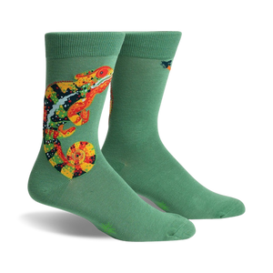Pair of sage green crew socks with a colorful chameleon design. The chameleon is orange, yellow, and black.