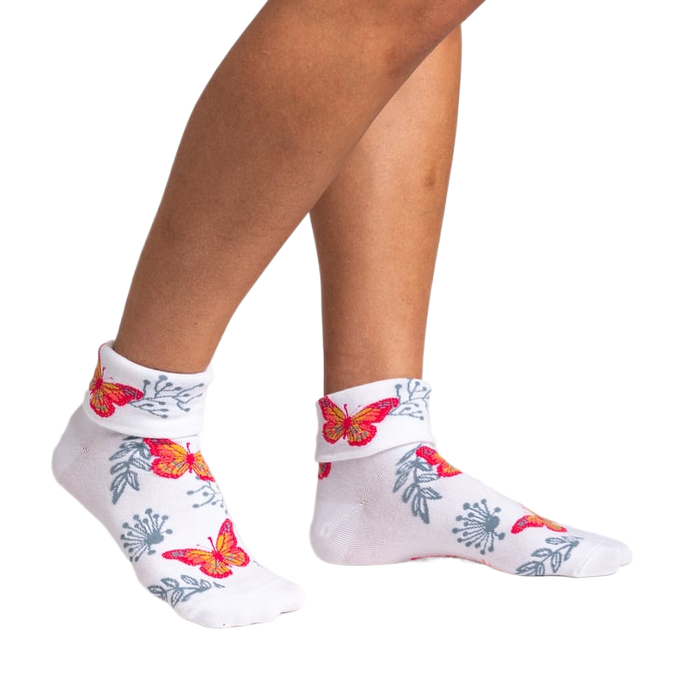 Pair of women's white ankle socks with butterfly and floral pattern shown from the front.