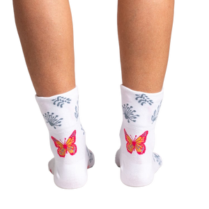 Close-up detail shot of a vibrant orange and pink butterfly design on the sock.