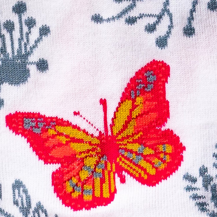 Lifestyle shot showing a model wearing the butterfly and floral ankle socks.