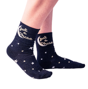Lifestyle shot showing a person wearing the 'Just A Phase' socks, showcasing how they look on feet.