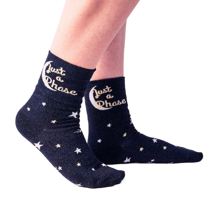 Lifestyle shot showing a person wearing the 'Just A Phase' socks, showcasing how they look on feet.