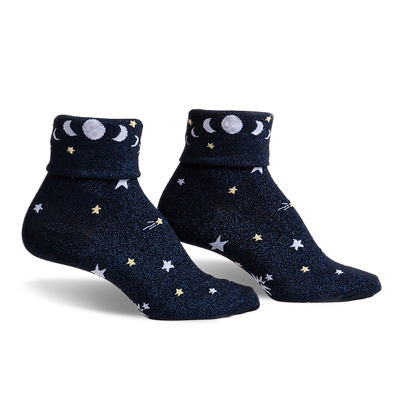Pair of navy blue sparkly socks with white and yellow stars, moons, and the phrase 'Just a Phase' on the cuff.