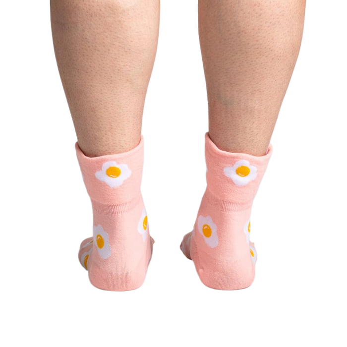 Back view of the socks on a person's legs, highlighting the design on the back of the socks.