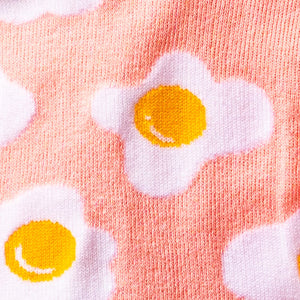 Close-up detail shot of the sock fabric, highlighting the fried egg design and texture.