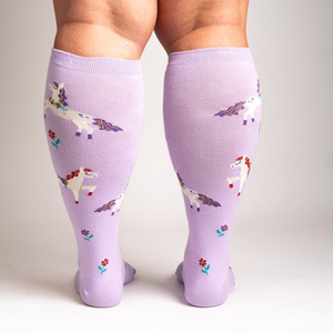 Back view of the socks on a person's legs, showing the full design and fit of the lavender unicorn knee-highs.