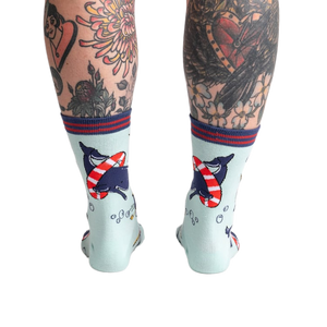 Back view of Whale-y Good Time socks on a model's legs, highlighting the design details on the back of the socks.