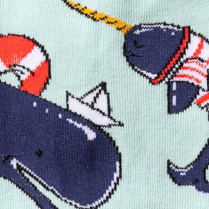 Close-up of Whale-y Good Time socks, emphasizing the detailed narwhal and nautical themed designs.