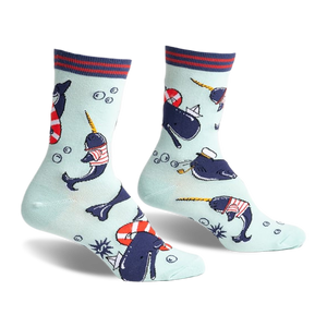 Crew socks featuring narwhals in sailor outfits, life preservers, and paper boats on a light blue background. Red, navy, and white details.