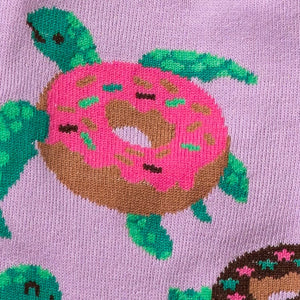 Close-up detail of the sock's design, showing a single turtle carrying a pink donut.